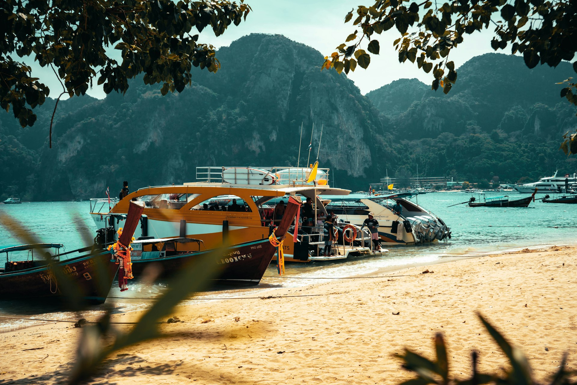 a group of boats sitting on top of a sandy beach